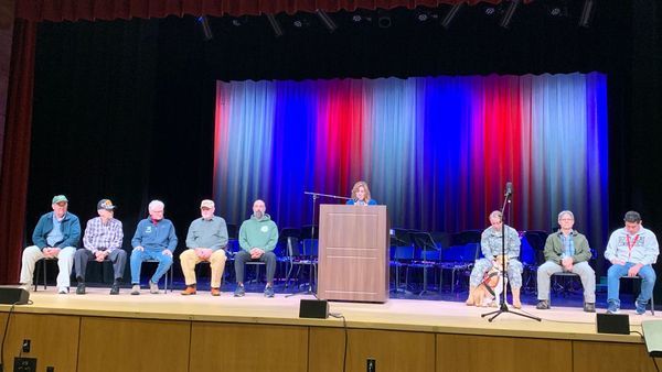 Staff and veterans on stage at event